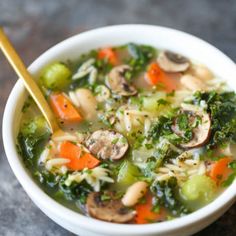 a white bowl filled with soup and vegetables