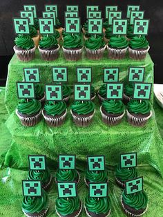 cupcakes with green frosting are arranged in the shape of squares and crosses