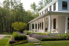 a white house sitting on top of a lush green field