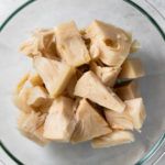 chopped bananas in a glass bowl on a table