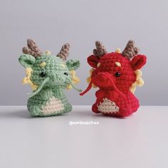 two crocheted stuffed animals sitting next to each other