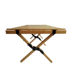 a folding wooden table with black straps on it