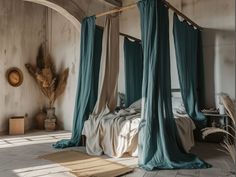 a canopy bed with blue drapes in a bedroom