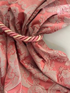 the pink and white fabric is tied up with a knot on it's end