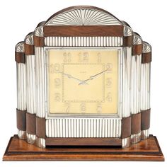 an art deco clock with glass and wood accents