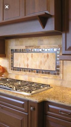 a stove top oven sitting inside of a kitchen next to wooden cabinets and counter tops