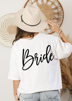 a woman wearing a white t - shirt with the word bride printed on it