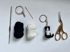 three crocheted items are sitting on a table next to knitting needles and scissors