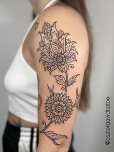 a woman with a flower tattoo on her arm