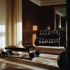 an empty gym room with dumbs and weights