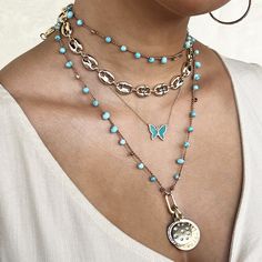 Double Disc CZ Charms On Faux Turquoise Bead Braided String Necklace Add a pop of color to any outfit with our Turquoise Charm Necklace. This beaded necklace is adorned with playful charms that will add a fun touch to your style. Perfect for any occasion, this necklace will bring a touch of whimsy to your wardrobe. Yellow Gold Plated Sunburst Charm: 0.97" Wide Moon & Star Charm: 0.77" Wide 32" Long Butterfly Chain Necklace, Diamond Charm Necklace, Jennifer Miller, Dagger Necklace, Turquoise Butterfly, Butterfly Chain, Moonstone Drop Earrings, String Necklace, Diamond Ear Cuff