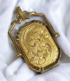 14k Vintage Victorian Style Gold Floral Embossed Rectangular Swivel Locket 23mm x 34mm This will make a UNIQUE and BEAUTIFUL GIFT * Polished up by my jeweler looking like new! Beautiful locket crafted of 14k yellow gold! * Large swivel design in a rectangular shape with intricate detail! * Locket measures approximately 23mm X34mm * Total weight 6.6 grams of 14K Gold!! Shipped FAST, gift boxed and insured with delivery confirmation I guarantee item to be exactly as described and pictured Luxury Gold Locket Necklace With Polished Finish, Luxury Antique Round Locket Necklace, Luxury Gold Locket Necklace, Luxury Yellow Gold Locket Necklace, Luxury Vintage Keepsake Necklaces, Cheap Vintage Gold Locket Necklace, Luxury Antique Oval Locket Necklace, Unique Locket Necklace, Watch Locket