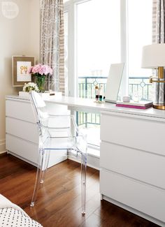 a white desk with a laptop on top of it next to a window in a bedroom