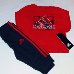 Brand New Never Worn With Tags. Adidas Set Includes A Red Long Sleeve Cotton Blend Tee Top With Classic Adidas Inscription On Front In White And Black Trim Blend. Bottoms Are Black Cotton Blend Design With Elastic Waistline And Classic Adidas 3 Pale Logo And Inscription On Left Leg With Banded Leg Opening And 3 Red Stripes Down Each Outer Leg. Set Fits 3 Months Boys Infant. Any Questions, Please Contact Me. Thanks! Sporty Red Long Sleeve Set, Red Long Sleeve Sports Sets, Red Sports Sets For Winter, Red Winter Sports Sets, Adidas Cotton Sets For Winter, Adidas Cotton Winter Sets, Red Cotton Sports Set, Sporty Red Playwear Set, Red Sporty Playwear Sets