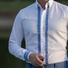 Thanks for stopping by! White shirt with traditional Romanian motifs. The traditional motifs are represented by a band applied on the shirt fabric made of 100% cotton. The collar is classic and the cuffs are straight. This product comes with a modern fashion bracelet as a gift. there are 5 models exposed ( from 1 to 5 ) please choose which one you prefer and let us know! Traditional Embroidered Shirt For Formal Occasions, Handmade Shirts, Modern Fashion, White Shirt, Fashion Bracelets, Free Gifts, Mens Shirts, Fabric, T Shirt