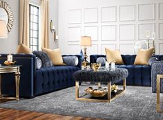 a living room with blue couches and gold accents