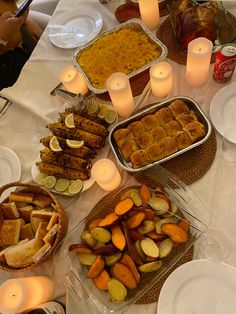 a table filled with food and candles on top of it