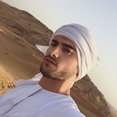 a man wearing a white turban in the desert