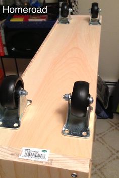 two black casteors are attached to a wooden board