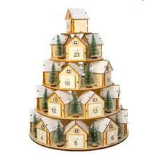 a wooden christmas tree with houses and trees on the top, numbered in white numbers