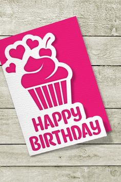 a pink card with a cupcake on it and the words happy birthday written in white