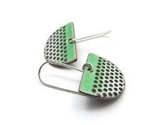 These green dangle earrings are handmade from copper half circles and many layers of vitreous enamel in green, black and white. Finished with handcrafted sterling silver earwires. Total length 3.4cm (1 3/8 inches). The half circles are enameled on both sides to distribute the tension of glass and metal evenly and prevent cracking or warping. The backside is black. The earrings will come packed in a small jewelry box ready for gift giving. MADE TO ORDER. Usually it takes two or three days until I can ship them. Same style different colors? See here: http://etsy.me/2lQ74hZ ----- Enameling is fusing powdered glass to metal at high temperatures. Torch firing allows me to have more control over the process and to observe how the powder softens, flows, and then hardens to a smooth, durable vitre Enameling Ideas, Ceramic Accessories, Enameling Jewelry, Clay Buttons, Green Dangle Earrings, Vitreous Enamel, Black Earrings Dangle, Ceramic Earring, Enamel Necklaces