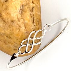 925 Sterling Silver Bangle, Bracelet Celtic Knot Sterling Silver Round Close Bangle, Interweave Bangle ------------------------------------- Details: Bangle Inside- 2.5 Inch X 2 Inch, Celtic Length- 1 1/4 Inch Celtic width- 1/2 inch There could be a fluctuation in the Dimensions. ------------------------------------- Do Visit our Shop for more jewelry: https://www.etsy.com/shop/InsiaJewelry ---------------------------------- Description: All jewelry always unless specified - nickel and lead free Sterling Silver Braided Bracelet With Silver Clasp Gift, White Gold Sterling Silver Braided Bracelet As Gift, White Gold Sterling Silver Braided Bracelet For Gifts, Sterling Silver Braided Bracelet With Silver Clasp, Elegant Round Sterling Silver Braided Bracelets, Sterling Silver Braided Bangle Bracelet As Gift, Adjustable Sterling Silver Bangle, Silver Sterling Silver Braided Bangle Bracelet, Elegant Braided Bangle Bracelet With Sterling Silver Clasp