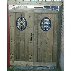 a wooden gate with two circular windows on it