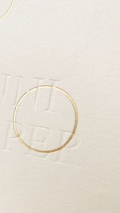 a close up of a piece of paper with a gold circle on top of it