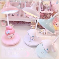 there are many toys on the table with pink and blue accessories around them, including an elephant lamp