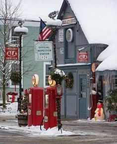 two red phone booths in front of a building with snow on the ground and american flags