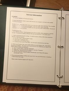 an open binder with instructions on how to use the internet information system for business