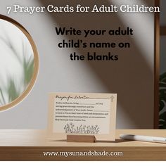 a note sitting on top of a desk next to a magnifying glass with the words prayer cards for adult children