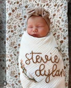 a newborn baby wrapped in a blanket with the words steve o'year written on it