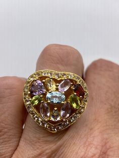 Lovely and delicate Bohemian ring  golden 925 Sterling silver  Deco ring set with genuine citrine, amethyst blue topaz and peridot  Heart is surrounded by tiny diamonds  Size 5 or 9 but can be re sized for you on request by laser.  My jeweler charges $20  All rings are shipped in a nice gift box.   Check out our over a THOUSAND great reviews Engraving is $4 per letter and is not always perfect depending on the piece. It can take a few days if the jeweler is busy. This is payable to Paypal Judith Multi-stone Ring Gemstones For Gift, Fine Jewelry Heart Cut Multi-stone Rings, Elegant Multi-stone Heart-shaped Rings, Elegant Multi-stone Heart Rings, Fine Jewelry Topaz Ring Gift, Oval Multi-stone Topaz Ring Gift, Topaz Stone Ring Gift, Heart-shaped Multi-stone Rings For Gift, Topaz Rings With Stones For Gift