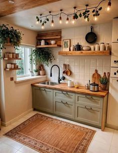 a kitchen filled with lots of green cupboards and counter top next to a window