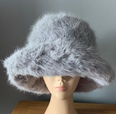 MORE SUITABLE FOR BIGGER HEADS Rihanna Style on Trend faux fur bucket hat REAL PICTURES  8cm brim 10cm top height  Fuzzy bucket hat 100% polyester  58cm head circumference has adjustable ribbons to reduce size Hat adjustable Please note defects can not be ruled out The colours you will see on the monitor may slightly differ with the colours you will see in real life Please note texture ,fabric fluffiness can not determined by picture as  pictures will always see fluffier than in real life. Buy with confidence as I have high standards of what I sell All questions welcome Please allow a margin of error on all measurements. Thank you Adjustable Brimmed Faux Fur Hat, Adjustable Faux Fur Brimmed Hat, Fluffy Faux Fur Wide Brim Hat, Winter Wide Brim Bucket Hat One Size, Winter Wide Brim Bucket Hat, One Size Brimmed Winter Sun Hat, Flat Brim Winter Hats One Size, Winter Flat Brim Hat One Size, Flat Brim Winter Hat