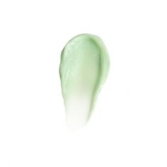 a close up view of a green substance on a white background, with the tip of an object visible