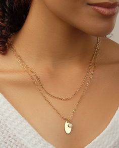 Add dainty details to your favorite looks with this layered piece! It features a smooth disk charm and a glam opal charm. This necklace is available in gold and silver tones. Materials: 14K gold or rhodium plated brass, created opal Features: Measures 16-18" with 2" extender, 0.35" & 0.75" pendants, 5mm opal stone, 2mm chain, Lead & Nickel free, lobster clasp Chain Layered Necklace, Figaro Chain Necklace, Pearl Chain Necklace, Layered Necklaces Silver, Figaro Chains, Gold Necklace Layered, Opal Stone, Layered Necklace, Pearl Chain