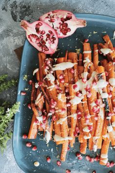 roasted maple glazed carrots with pomegranate and white glaze on top