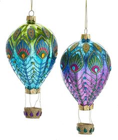 two colorful hot air balloons hanging from chains on a white background, one is blue and the other is green