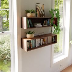 two wooden shelves with books and plants on them in front of a large open window