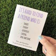 someone holding up a card that says it's hard to find a friend who is