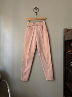 "Vintage Lee Riveted dusty pink jeans with tapered leg and high waist. In overall excellent condition, no flaws to note whatsoever. Made in USA Tagged size 6 Med, fits best a 26 inch waist. Measured flat: Waist 13\" Rise 12.5\" Hips 38\" Inseam 31\" PLEASE READ! *MEASUREMENTS* All items are measured while laying flat and unstretched. For clothing: chest, waist, hip and thigh measurements should be multiplied by two. All measurements are in inches. *VINTAGE CONDITION* Vintage goods may show signs of wear and age. We always indicate and/or show in pictures any major flaws or blemishes, but will not always mention small flaws, such as pinpoint sized spots or holes. If you are concerned about a particular item's condition, please message us. All of our pieces are pre-owned. We use a natural de 90s Pink Straight Leg Bottoms, 90s Style Pink Cotton Jeans, Vintage Pink Jeans For Spring, Vintage Pink Cotton Pants, Vintage Pink Straight Leg Jeans, 90s High Waist Pink Bottoms, High Waist Pink 90s Bottoms, Pink High Waist 90s Bottoms, Vintage Pink Cotton Jeans