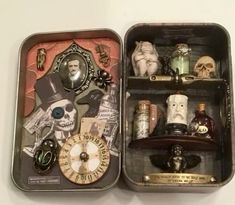 an open tin box filled with assorted items