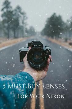 a person holding up a camera with the words 5 must buy lenses for your nikon