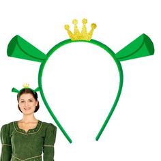 a woman standing in front of a green headband with a crown on top of it