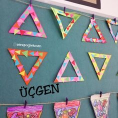 colorful paper triangles hanging on a line with the word ucgen written below them in spanish