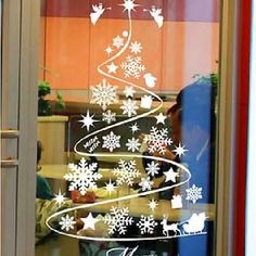 a christmas tree made out of snowflakes is seen through a window with the words happy new year written on it