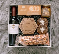 a wine bottle and some snacks in a box